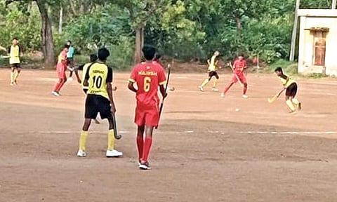 Young boys playing hockey on gravel pitch at Vadipatti&nbsp;