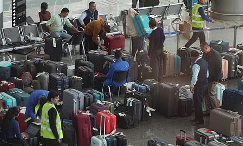 Passengers try to find their luggage amongst the piled-up lot at the Indira Gandhi International Airport amid IndiGo flight disruptions, in New Delhi, Monday, Dec. 8, 2025. (PTI)&nbsp;
