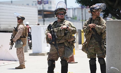 Members of the California National Guard and U.S. Marines guard a federal building in Los Angeles (AP)&nbsp;