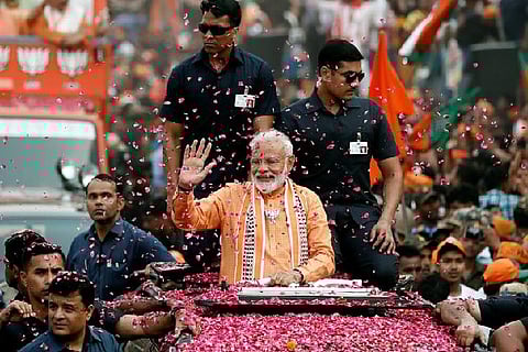 India's Prime Minister Narendra Modi waves towards his supporters during a roadshow in Varanasi, India, April 25, 2019