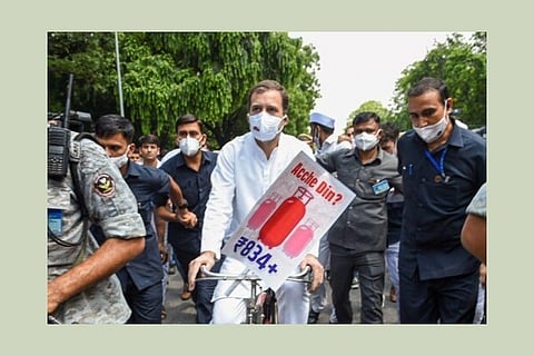 Congress leader Rahul Gandhi rides a bicycle in a symbolic protest over fuel price hike