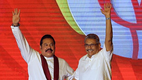 Mahinda Rajapaksa, left, and his brother Gotabaya Rajapaksa wave to supporters during a party convention held to announce the presidential candidacy in Colombo, Sri Lanka, Aug. 11, 2019. Sri Lanka's President Gotabaya has agreed to replace his older brother Mahinda as prime minister in a proposed interim government to solve a political impasse caused by the country's worst economic crisis in decades, a prominent lawmaker said Friday, April 29, 2022.