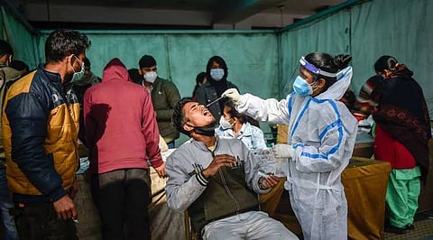 A health worker collects a Covid sample from a person