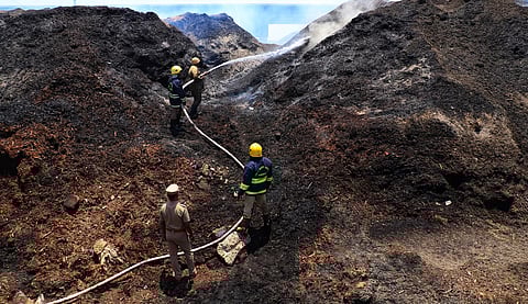 Fire fighter splashing water to douse the fire