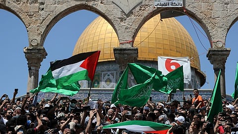 Protestors waving Palestinian flag.