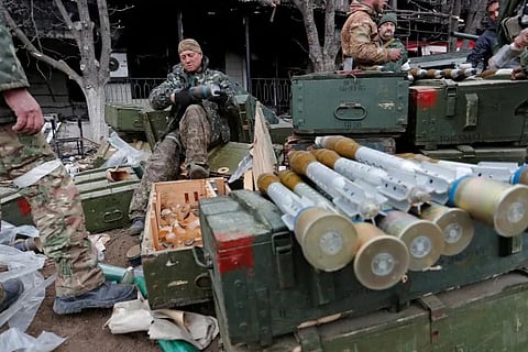 Service members of pro-Russian troops load rocket-propelled grenades during fighting near a steel plant in Mariupol, Ukraine