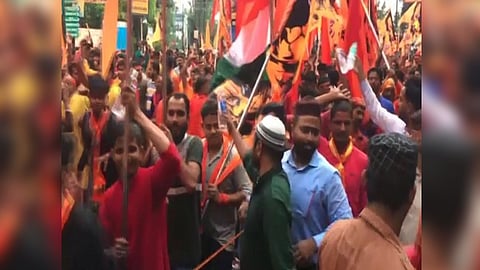 Muslim youths distributing water bottles (Source: ANI)
