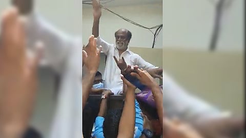 Rajinikanth waving at his fans.