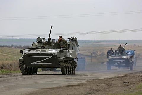 Russian military vehicles move on a highway in an area controlled by Russian-backed separatist forces near Mariupol