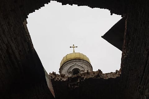 A hole in the roof of a damaged church, in Lukashivka, near the city of Chernihiv in northern Ukraine, on Friday, April 22, 2022. A single metal cross remains inside the Orthodox church of shattered brick and blackened stone. Residents say Russian soldiers used the house of worship for storing ammunition, and Ukrainian forces shelled the building to make the Russians leave.