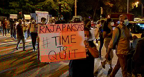 Protestors hold banners and placards during a demonstration
