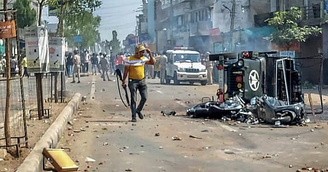 A burnt vehicle in Gujarat's Himmatnagar city following communal clashes.