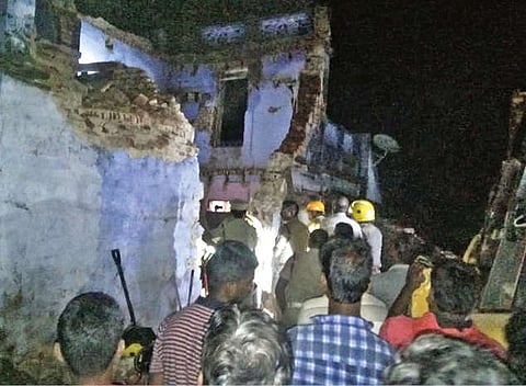 Revenue officials taking stock at house collapse site in Tenkasi on Tuesday