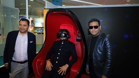 Anurag Thakur wearing the VR headset; AR Rahman stands to his left