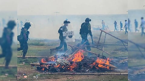 Paramilitary police personnel arrive at the site as demonstrators and government supporters clash outside the President's office in Colombo