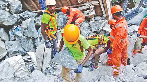Rescue personnel look for the body under the rubble