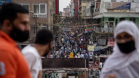 People are seen in a crowded marketplace amidst the spread of the coronavirus disease
