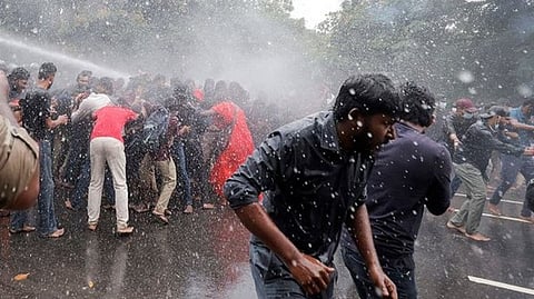 Police use water cannon on demonstrators during a protest near the Sri Lankan Parliament (Photo Credit: Reuters)