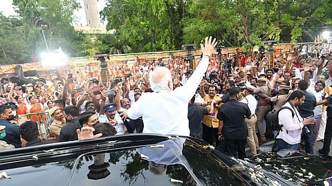Modi waving at the crowd