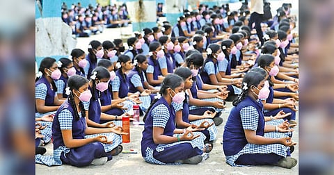 Students meditate before proceeding to exam halls at a school in Chennai