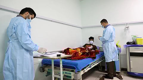 Doctors examine a patient infected with the tick-borne virus