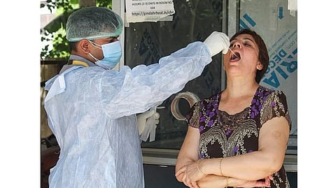 A healthworkers takes a Covid sample from a person