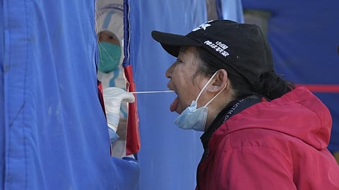 A resident gets swabbed during mass Covid-19 test