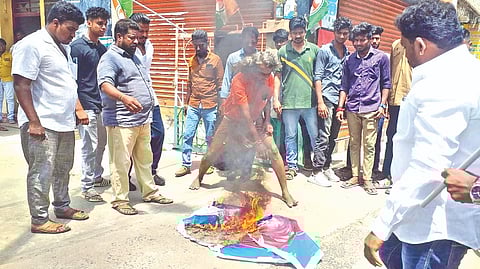 A Youth Congress functionary burning portrait of NTK chief Seeman in Tiruchy on Tuesday
