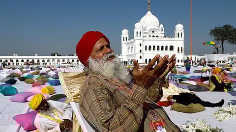 An Indian Sikh pilgrim offers prayers as he visits the Gurdwara Darbar Sahib in Kartarpur