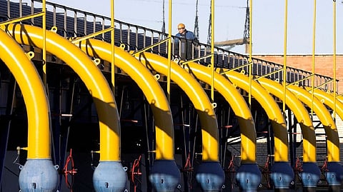 A worker checks pipes at a gas compressor station on the Yamal-Europe pipeline near Nesvizh