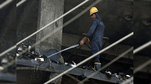 Firefighter douses fire at 4-storey building