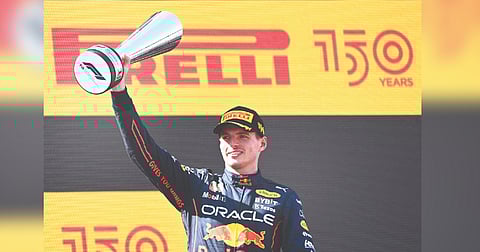 Max Verstappen celebrates on the podium after his triumph