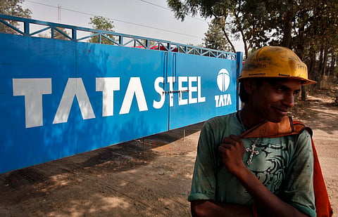 A labourer stands outside a Tata Steel stockyard