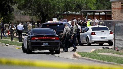 Law enforcement officers guard the scene of a shooting