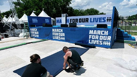 Workers set up for the March for Our Lives rally on the National Mall, near the White House, in Washington, Friday, June 10, 2022. The march is returning to Washington after four years.