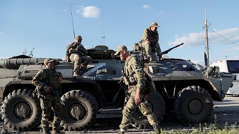Service members of pro-Russian troops wait before the expected evacuation of wounded Ukrainian soldiers from the besieged Azovstal steel mill in the course of Ukraine-Russia conflict in Mariupol, Ukraine