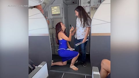 Alaska Airlines Pilot Alejandra Moncayo proposing to flight attendant Veronica Rojas in pride-themed aircraft