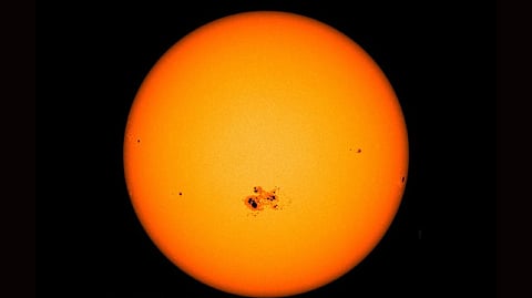 A gigantic sunspot can be seen on the lower center of the sun