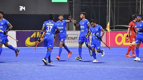 Indian players celebrate after scoring a goal.