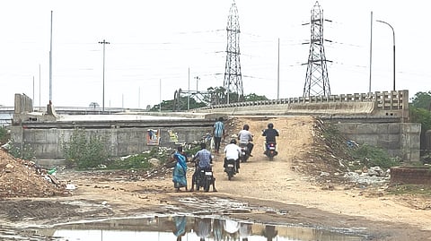 Motorists use temporary mud ramp to climb the bridge to travel between Manali & Tiruvottiyur