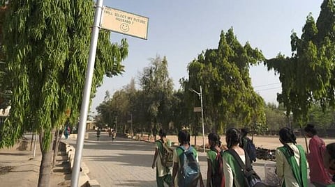 A group of girls walking towards the school to pursue their dreams.