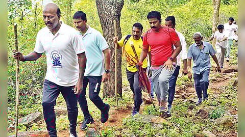 Health Minister Ma Subramanian trekking through hills to Kedamalai village in Bodhamalai in Namakkal on Tuesday