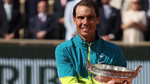 Rafael Nadal poses with The Musketeers' Cup as he celebrates after victory over Norway's Casper Ruud during their men's singles final match on day fifteen of the Roland-Garros Open tennis tournament.
