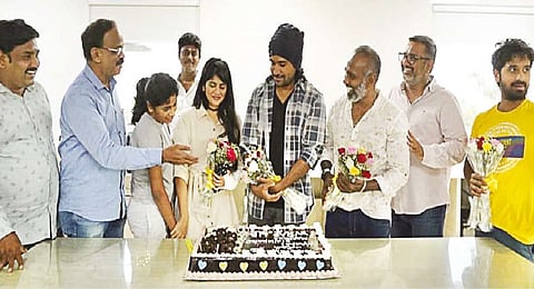 The team cuts a cake to celebrate the wrap up