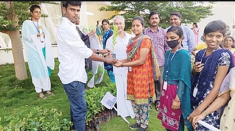 Vellore green champion award winner handing over 500 saplings to students of a private arts college in Gudiyattam on Saturday.