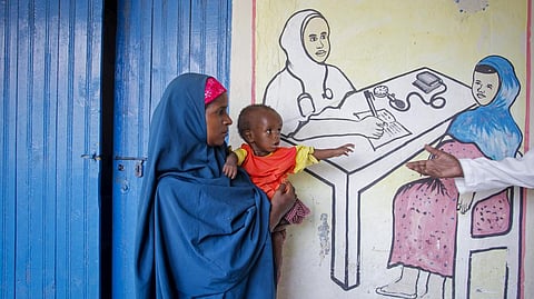 A Somali mother holding her malnourished baby