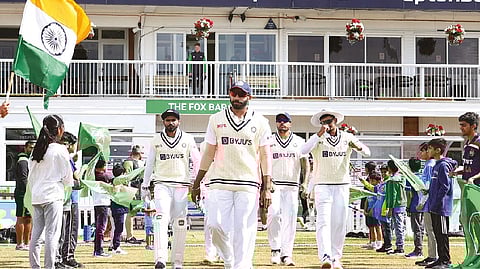 Jasprit Bumrah leads the India team onto the field