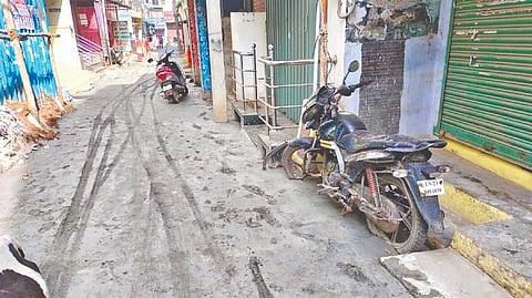 The shoddily laid cement road with a two-wheeler stuck in wet cement at BSS Koil Street in Vellore