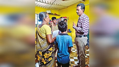 A government school teacher convincing a parent to send their wards to his school in Katpadi