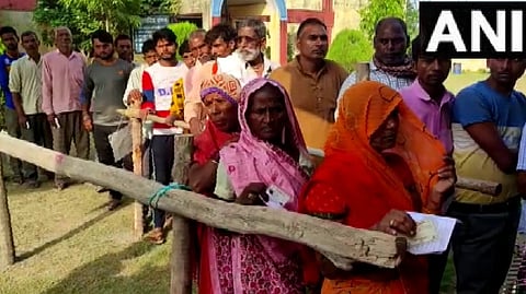 Voters at the Baniyapur polling booth at the Rampur constituency